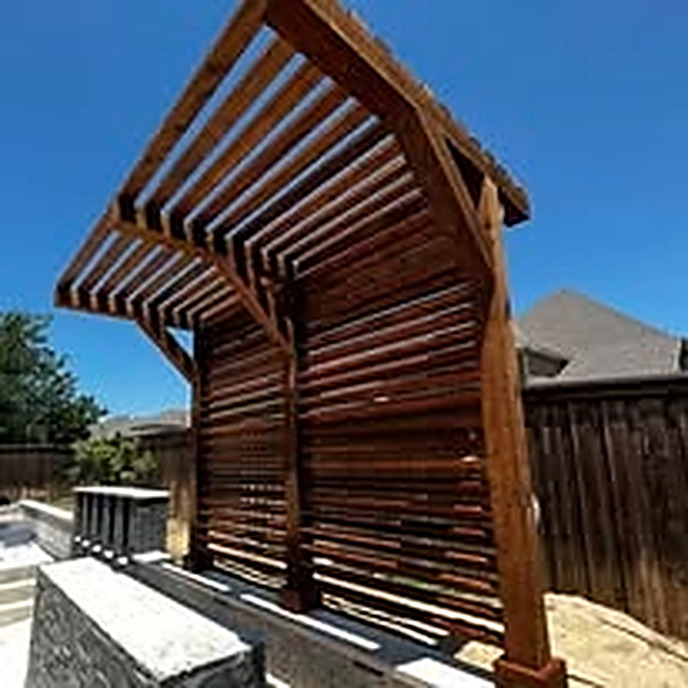 Custom curved-slat pergola with a stone pillar base