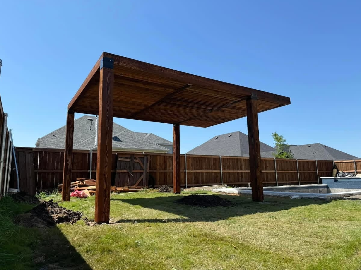 Freestanding flat-roof cedar pergola beside a backyard pool
